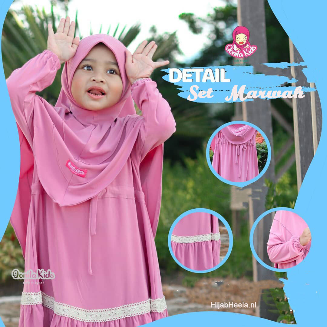 a little girl in a pink dress holding a frisbee