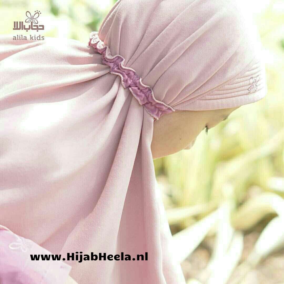 a pink umbrella that is in the grass