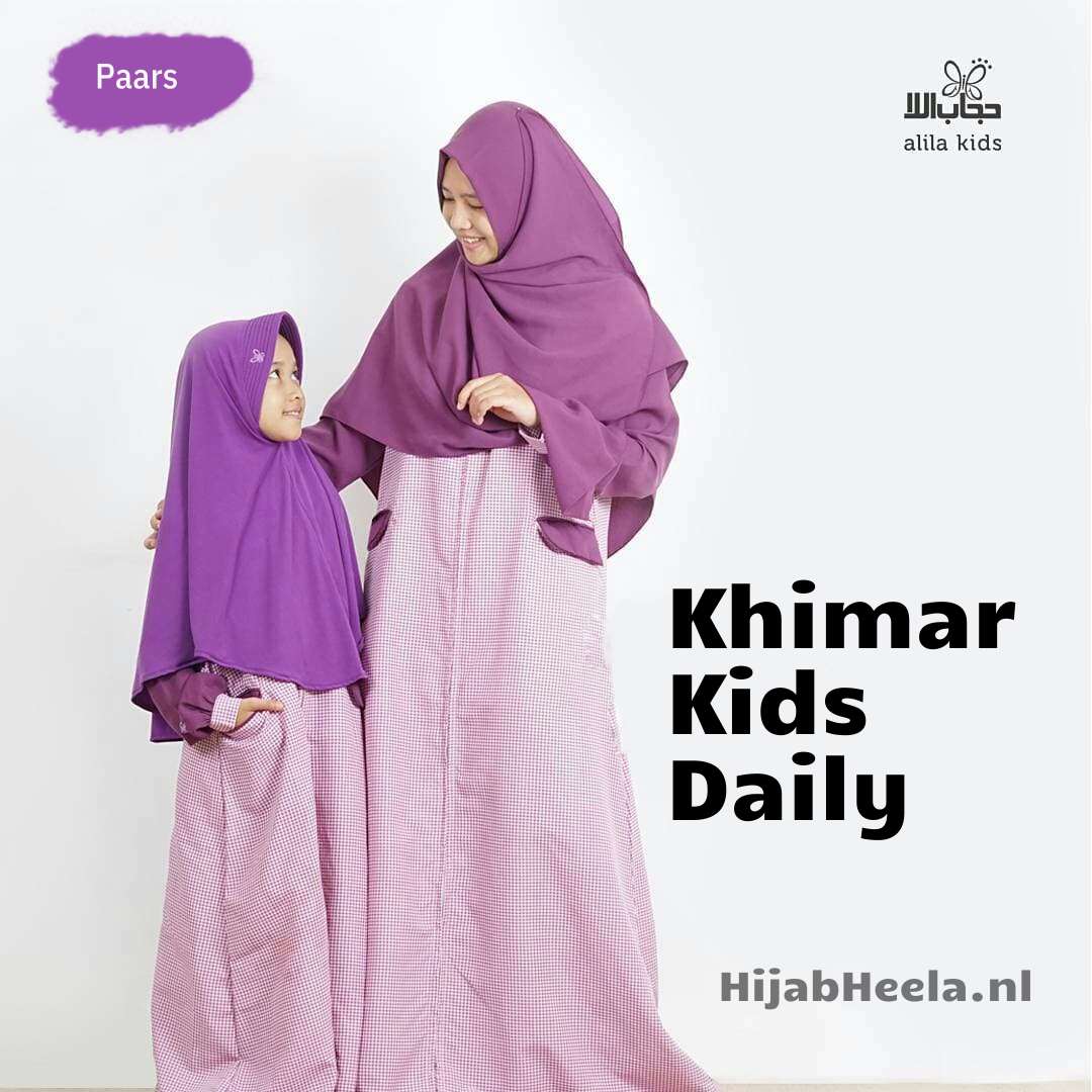 a woman in a pink dress holding a cell phone