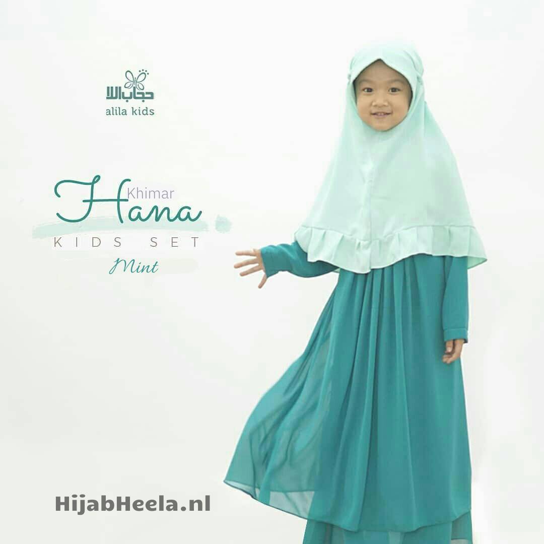 a woman in a green dress holding a cell phone